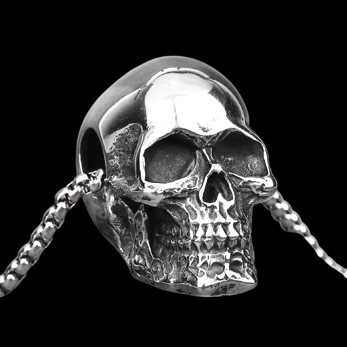 GOTHIC HOUR black polished stainless steel skull pendant necklace with detailed features on a textured stone surface.