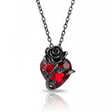GOTHIC HOUR Crimson Rose Necklace featuring a red heart crystal wrapped in sculpted black metal rose vines.