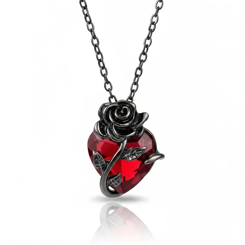 GOTHIC HOUR Crimson Rose Necklace featuring a red heart crystal wrapped in sculpted black metal rose vines.